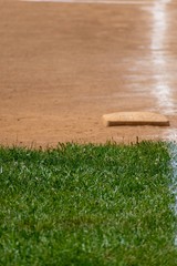 Chalk lines the field with the edge of the fresh grass and baseball base