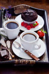 Black coffee in white cups and chocolate muffin for breakfast