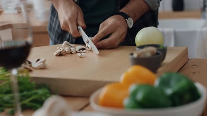 close up hands cutting mushrooms using knife preparing fresh homemade meal with sliced vegetables for cooking healthy organic lifestyle at home 4k footage - Powered by Adobe