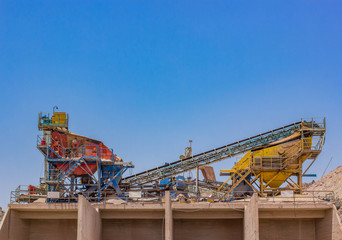 Fototapeta premium industrial buildings digging factory with disable and abandoned rust iron machines and production lines in symmetry wallpaper pattern photography concept on blue sky background with empty copy space