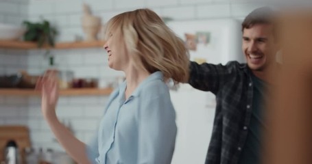 fun happy couple dancing in kitchen celebrating dance together enjoying playful romantic relationship at home 4k footage