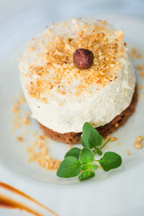 Cream cake with whole and ground hazelnuts