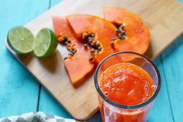 Glass of tasty papaya water and lime