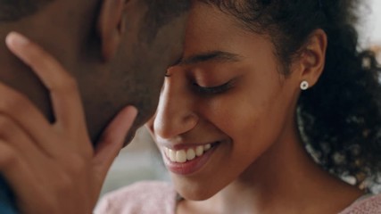 happy young mixed race couple enjoying romantic relationship boyfriend touching girlfriends face with gentle caress sharing love partners feeling intimate connection 4k - Powered by Adobe