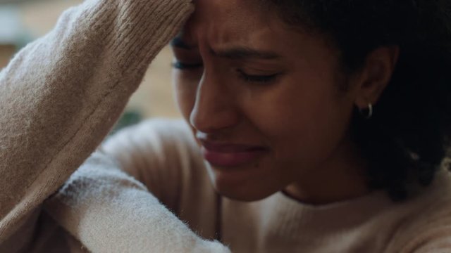 sad mixed race woman crying at home feeling unhappy over stressful break up stressed female upset over loss grieving relationship issues 4k footage depression concept