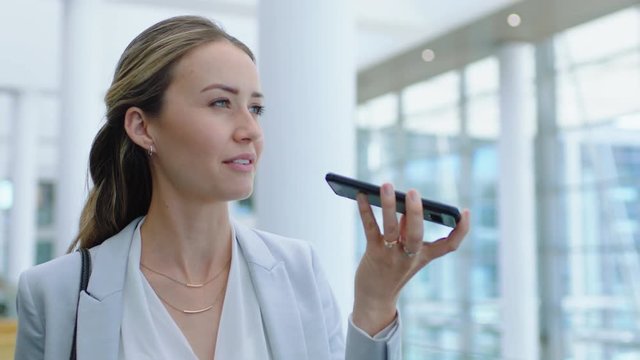 beautiful business woman using smartphone having phone call talking to client discussing work successful female executive walking in corporate office 4k