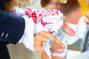traditional Ukrainian Christian Wedding. the priest tied his hands to the newlyweds with a wedding...