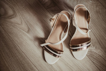 Bride shoes on wooden floor. Wedding accessories fashion background.