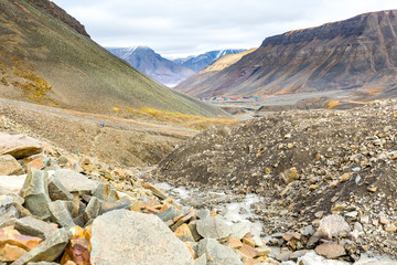 Hiking behind Longyearbyen towards glacier in the arctic tundra of Svalbard or Spitsbergen, northern Norway