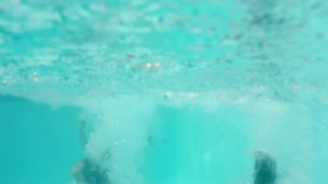 mother with children jumping in swimming pool together happy family playfully enjoying summertime having fun splashing in cool water