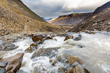 Hiking behind Longyearbyen towards glacier in the arctic tundra of Svalbard or Spitsbergen, northern Norway