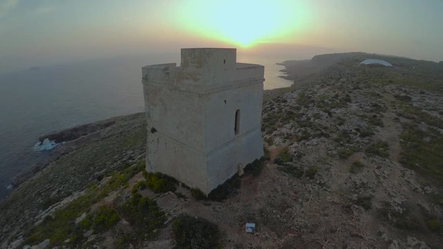 Aerial view of stone tower with sea in the background