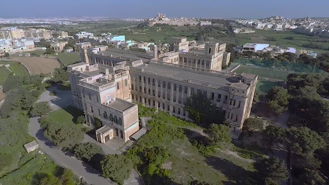 Aerial shot of school. Aerial shoot of frontage of school with nice surroundings and trees and green grass field near town