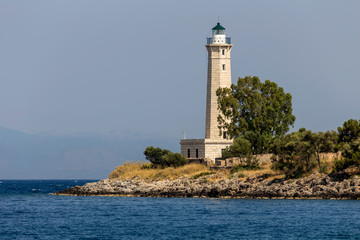 Fototapeta na wymiar Lighthouse near the city Gythio against the background of the sea and sky (Greece, Peloponnese)
