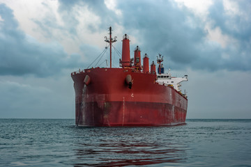 Bulk carrier vessel is awaiting loading of bauxite ore at outer anchorage of Kamsar port, Guinea,...