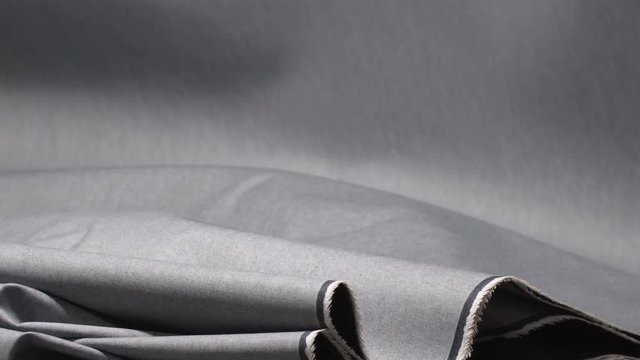 Stunning static shot of freshly woven denim clumping up in a denim production facility.