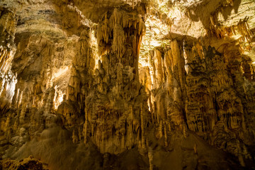 Fototapeta na wymiar Stalactites and stalagmites underground in cave system in Postojna