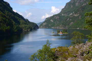 red house on small island in Lofrafjorden fjord in Norway