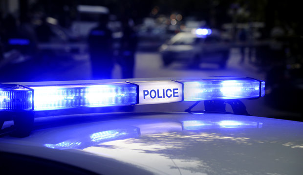 Patrol Police Car With Blue Emergency Lights In Traffic Accident Scene