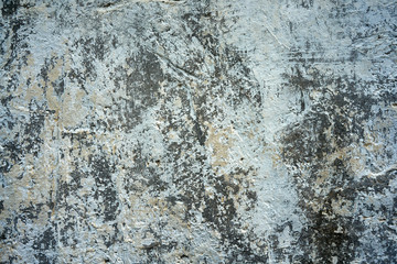 Close-up of old wall with peeling paint surface. Grunge background.