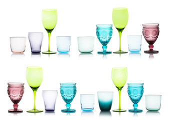 Set of different multicolored empty glasses on white background