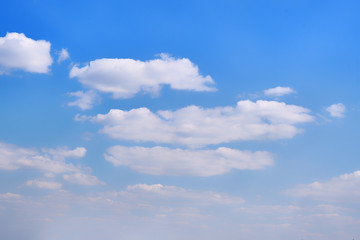 White clouds in clear spring weather. Sunny sky in the morning with floating clouds. Background of cloudy blue sky.