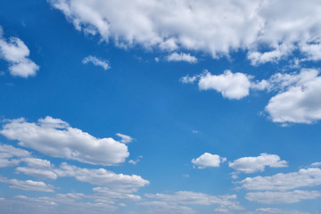 Background clouds on blue sky. White Cumulus clouds in clear weather. The sky on a Sunny summer day.
