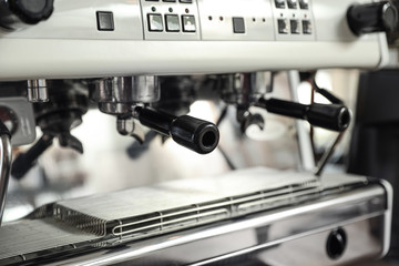 Modern coffee machine with portafilters, closeup view