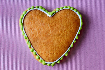 Gingerbread copy space. Baking heart close-up. Valentines day card. Pink background for the inscription. Place under text on cake. Cookie like a heart with icing