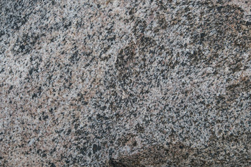 Background of natural stone. A snapshot of granite boulder (Latin 