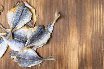 Salted fish lying on a wooden table