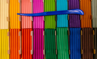 Color modeling clay with a plastic knife.
