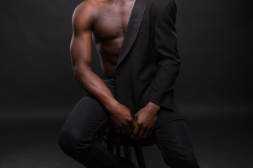 Fototapeta na wymiar Beautiful and muscular black man in dark background.