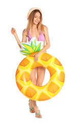 Beautiful young woman in stylish bikini with pineapple inflatable ring on white background