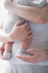 A child in the arms of a father or mother. New life. Newborn. Children and pregnancy. Baby and parents. Happiness, the continuation of the human race.