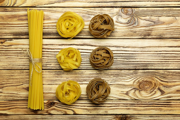 Collection of italian pasta top view on vintage wooden background.