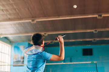 Badminton court with players. Tennis player with a racket. Badminton activity. Sports game of success. Happy kid playing badminton. The child beats the shuttle with a racket. - obrazy, fototapety, plakaty