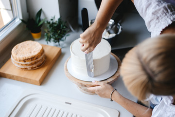 Girl baker prepares a delicious berries cheesecake