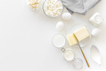 Eggs, butter, milk, yougurt, cottage for natural farm products yougurt on white background top view monochrome copyspace