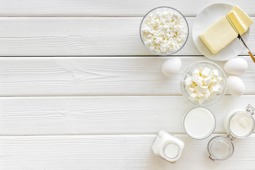 Eggs, butter, milk, yougurt, cottage for natural farm products yougurt on white wooden background top view copyspace