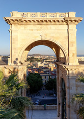 Cagliari, Italy. View of arch of Triumph and the city through the arch from the panoramic terrace on top of the bastion of Saint Remy.