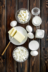 Eggs, butter, milk, yougurt, cottage, cheese for natural farm products yougurt on wooden background top view