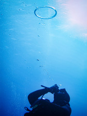 Scuba diver making ring of air oxygen under water