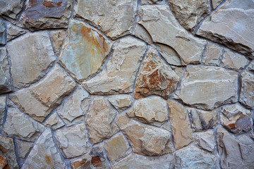 Close-up surface of the old dirty fence made of natural stone and cement.