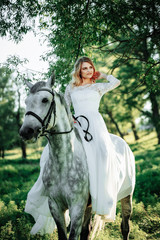Fototapeta premium Fashionable woman riding a horse in sunny day.