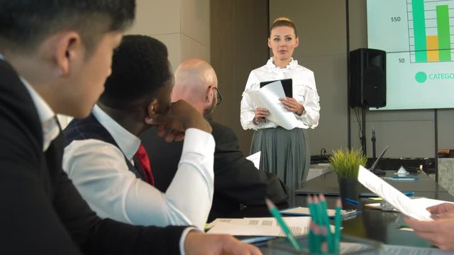 Director of the company speaks to colleagues with presentation of plans for the next year
