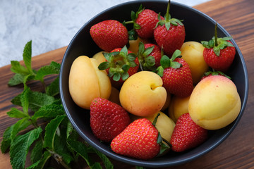 Healthy natural summer dessert. Strawberries and apricot.