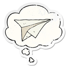 cartoon paper airplane and thought bubble as a distressed worn sticker
