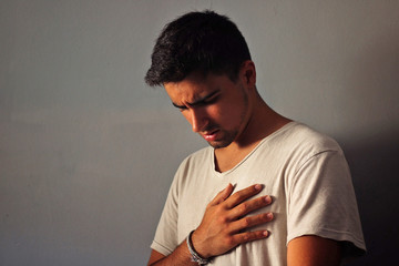 Man dressed in white with chest pain.