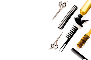 Combs, sciccors and hairdresser tools in beauty salon work desk on white background top view space for text